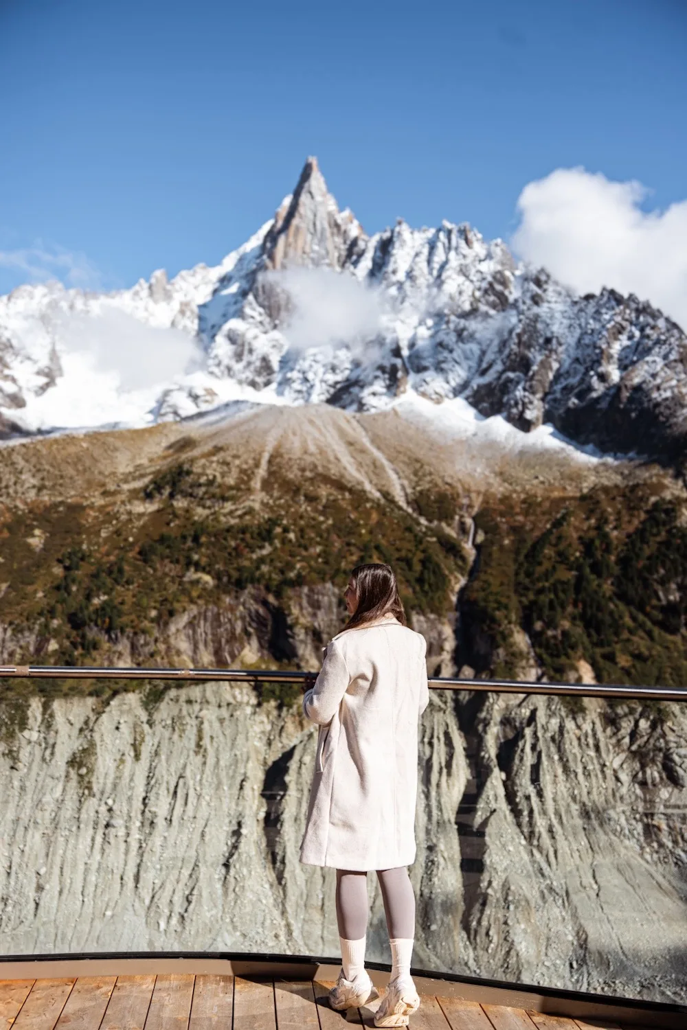 une personne de dos regarde un sommet enneigé à la mer de glace à chamonix